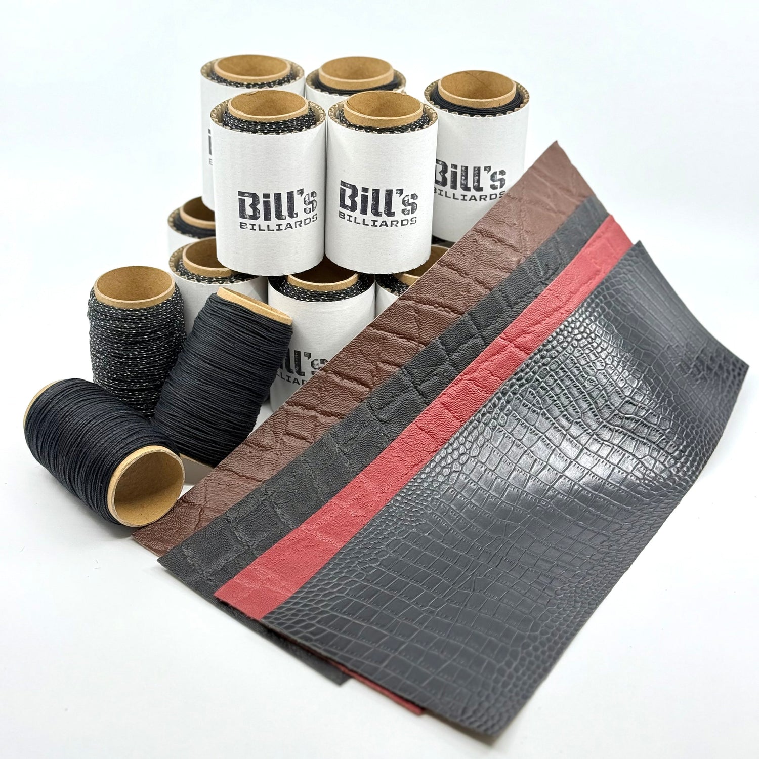Leather wraps for pool cues, four colors shown. Also 50yd rolls of Irish Linen. Multiple rolls shown.