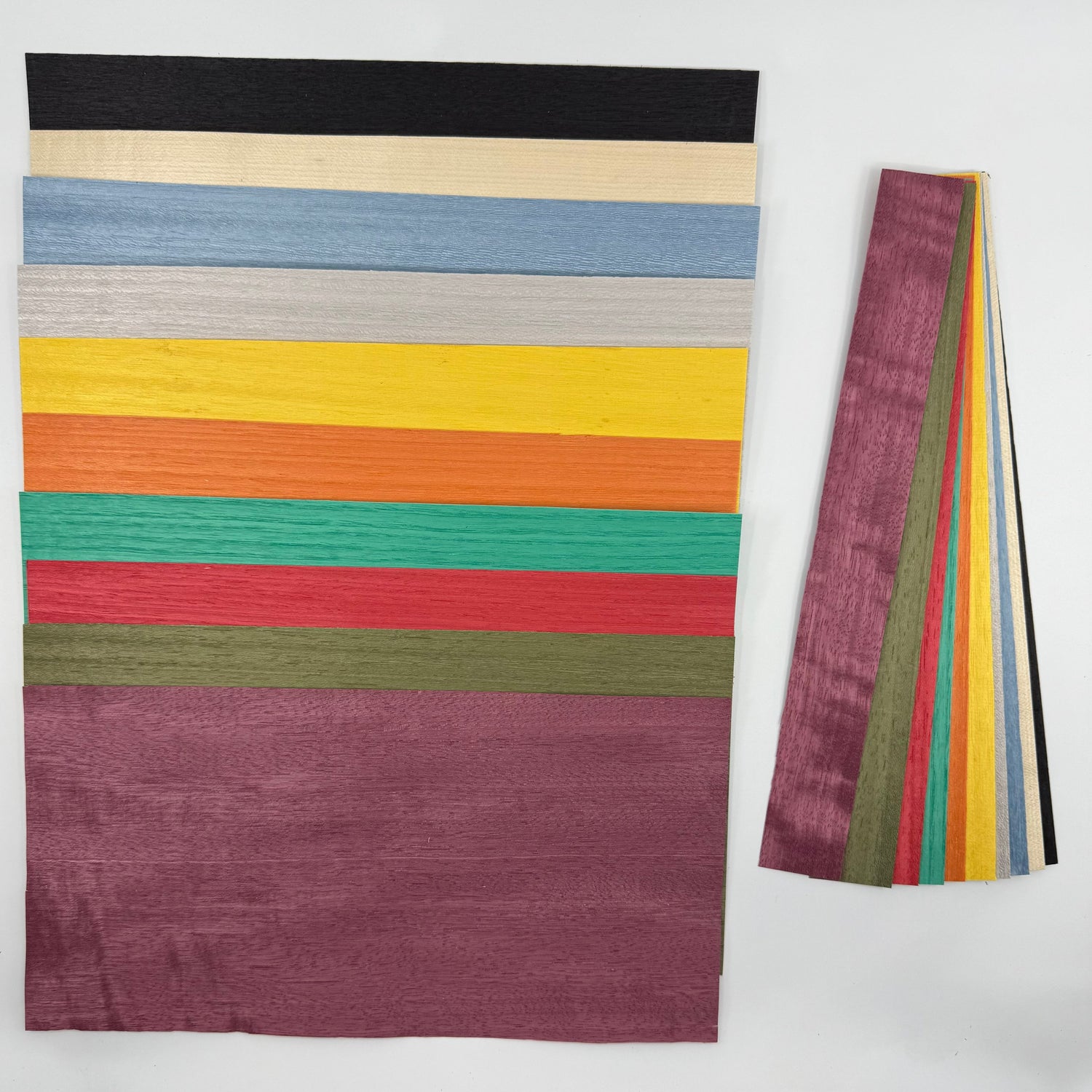 Image of brightly colored veneers for pool cues. 5.5 x 11" and 1.5 x 11 strips.