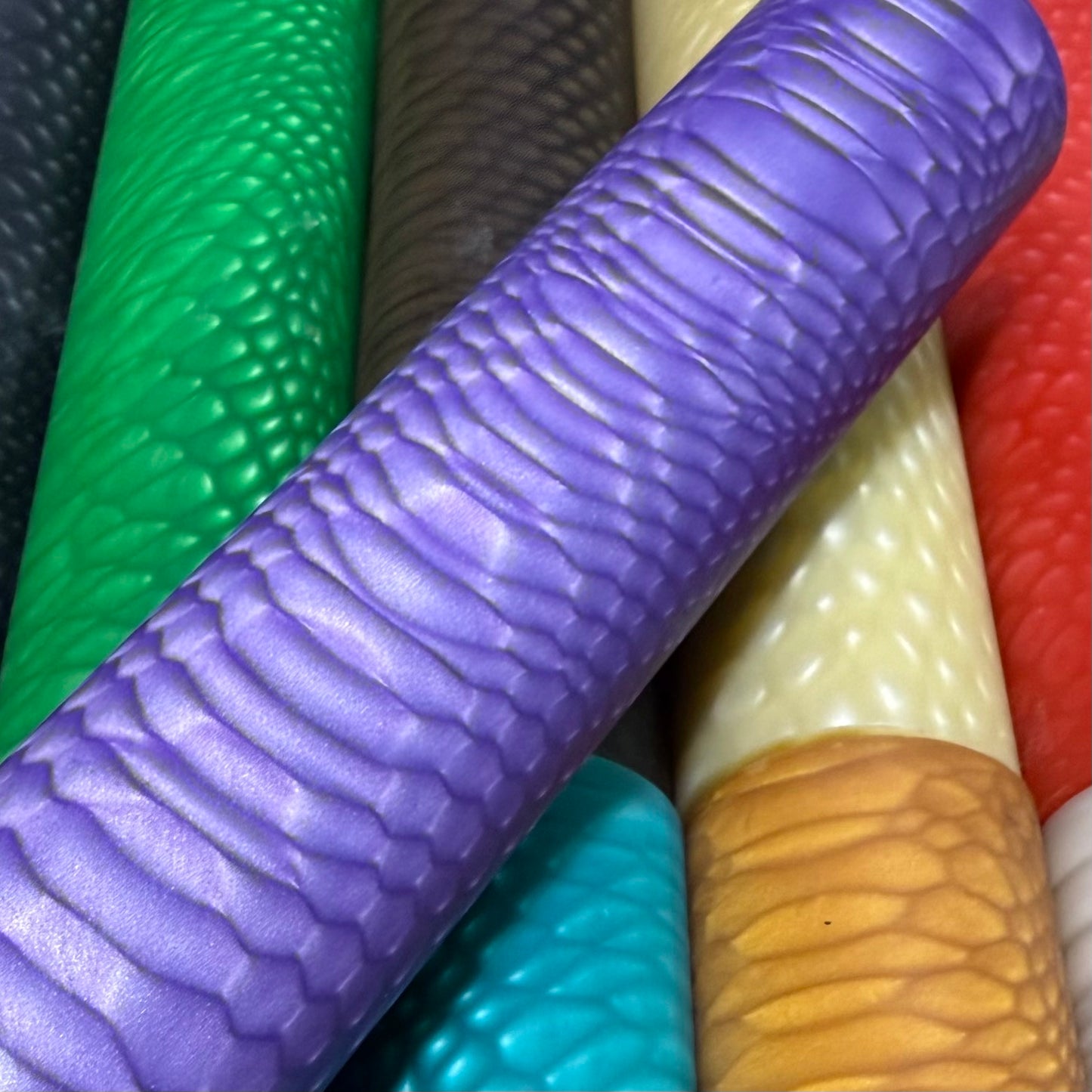 DragonSkin™ Material Royal Purple 32mm shown with other colors behind it.
