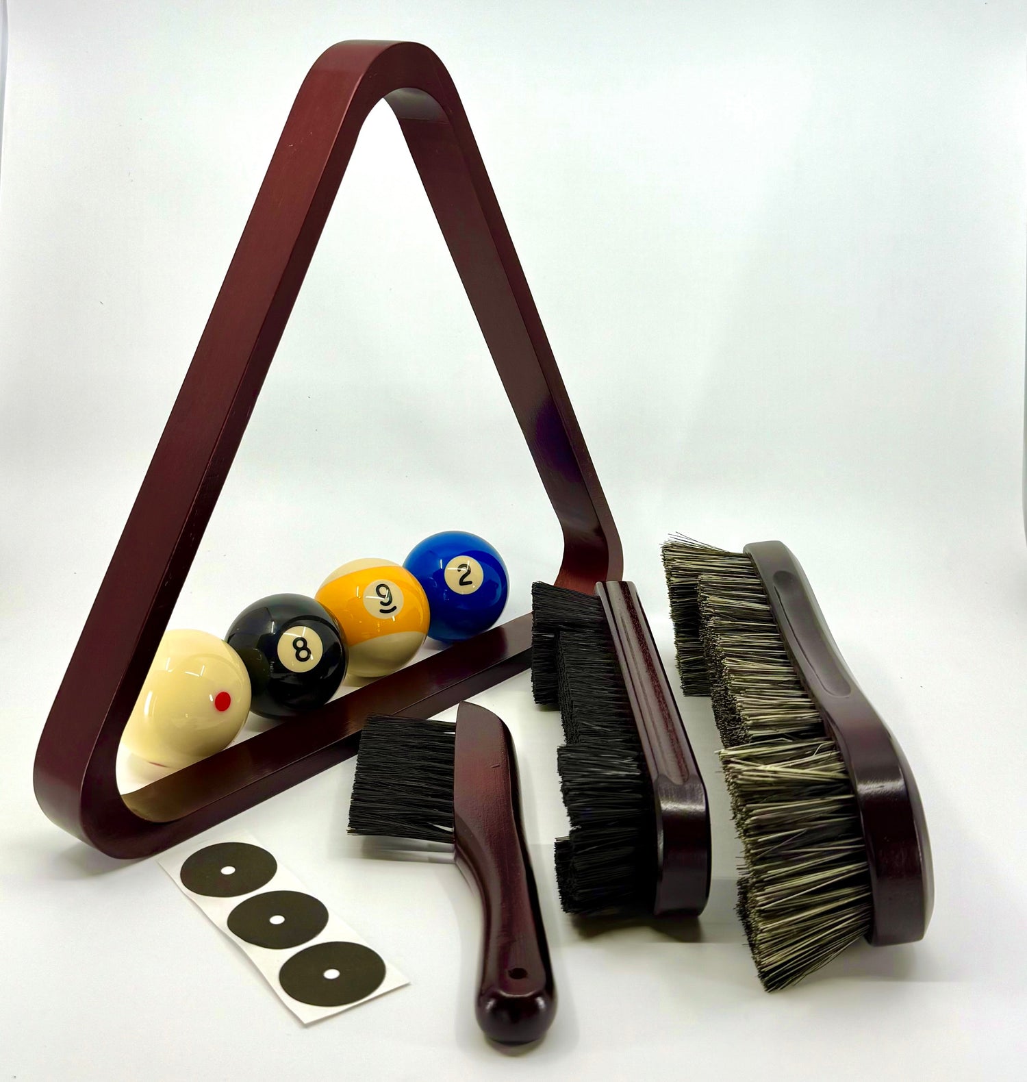 Billiards product for playing pool. The image includes mohogany colored rack, large table brush, small table brush and small rail brush, balls and spot. 