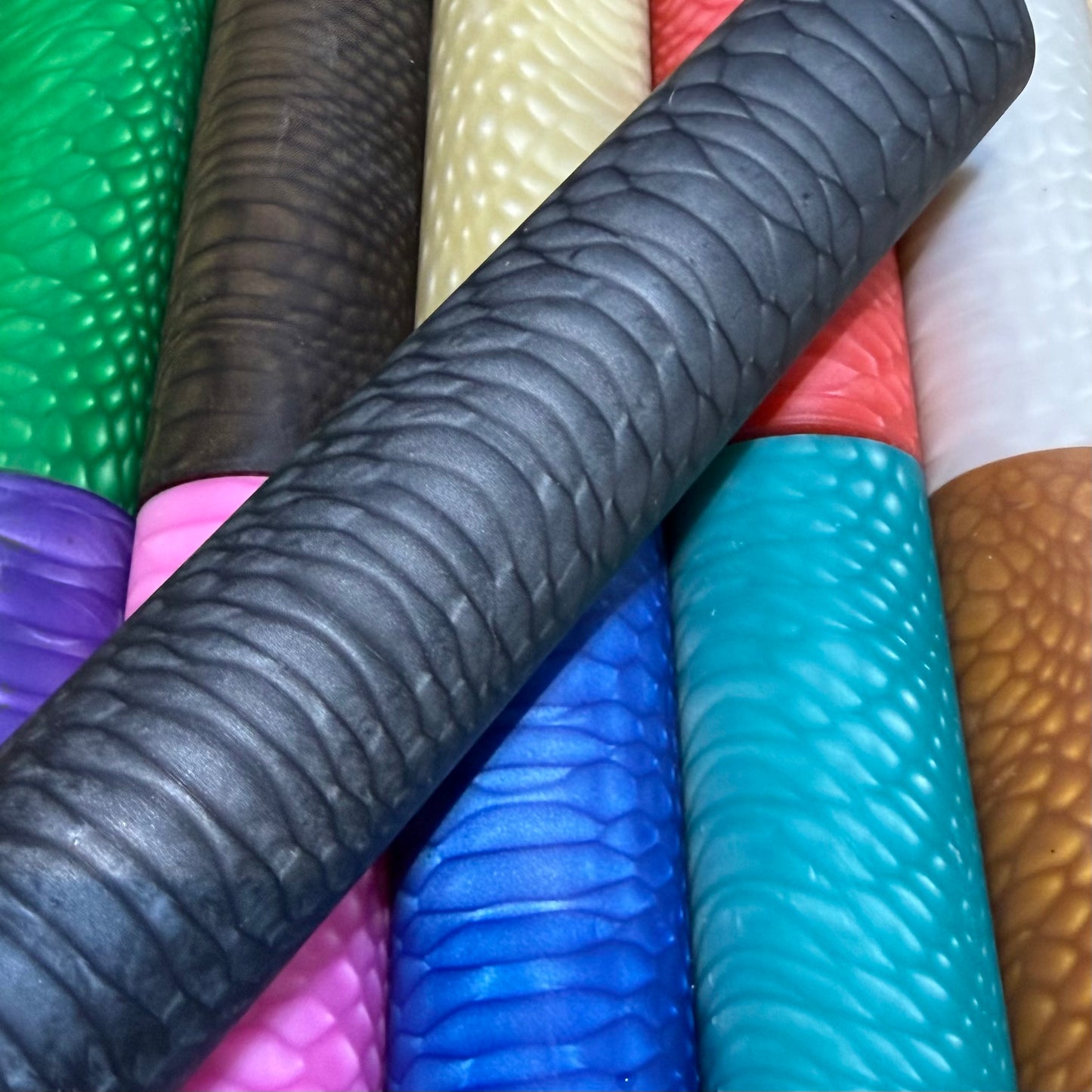 DragonSkin™ Material Storm Black 32mm shown with other colors behind it.