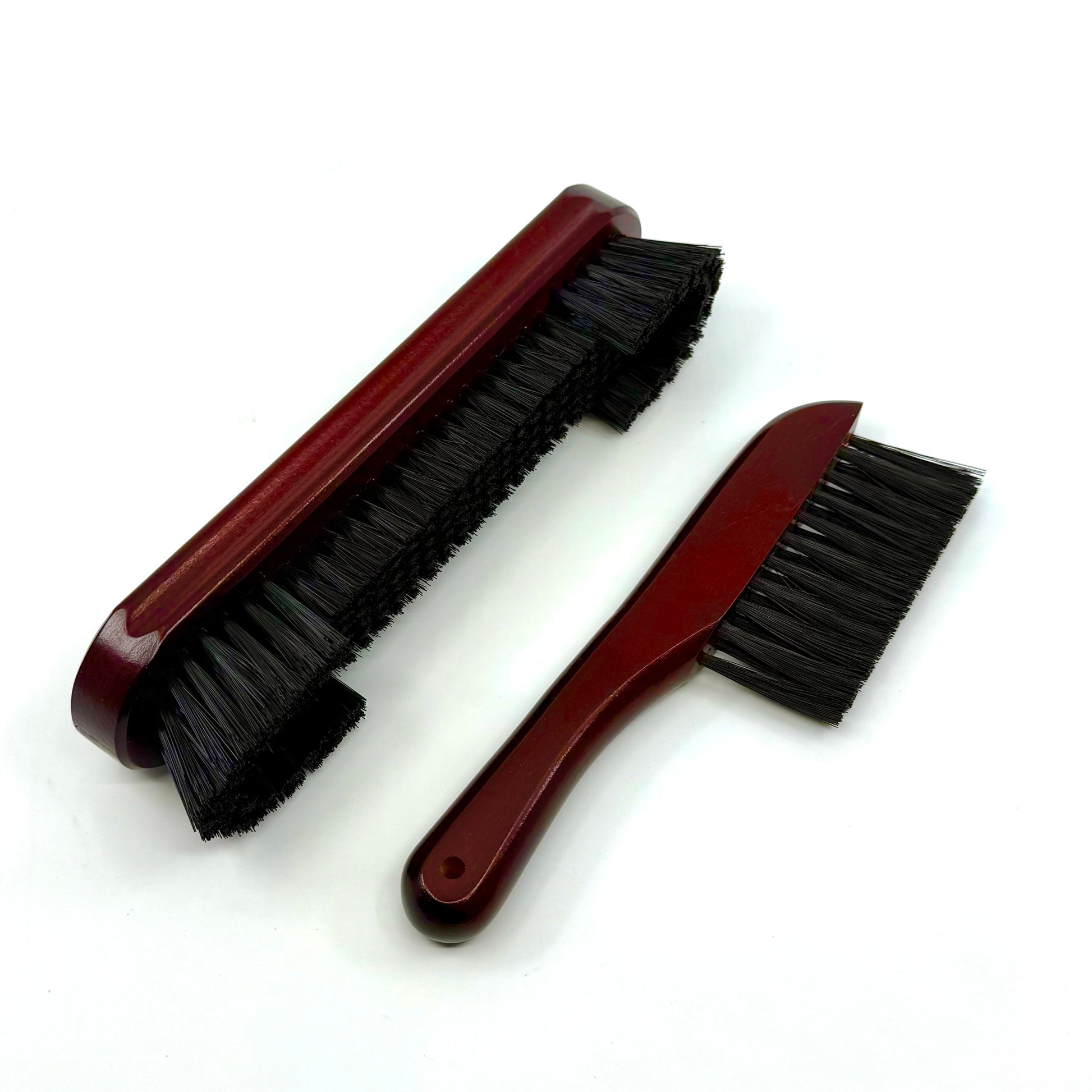 Image of  a two-piece billiards brush set with mahogany wooden handles and soft nylon bristles for cleaning pool table rails and corners.