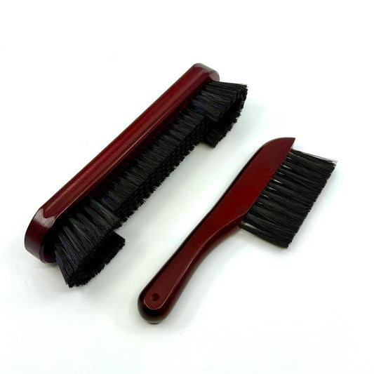 Image of  a two-piece billiards brush set with mahogany wooden handles and soft nylon bristles for cleaning pool table rails and corners.