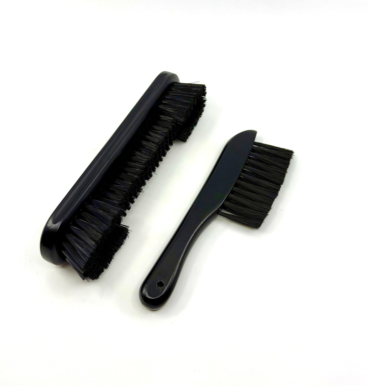 Image of a two-piece black billiards brush set with wooden handles and soft nylon bristles for cleaning pool table rails and corners
