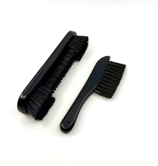 Image of a two-piece black billiards brush set with wooden handles and soft nylon bristles for cleaning pool table rails and corners